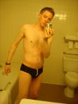 Black speedos, changing in a bathroom