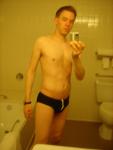 Black speedos, changing in a bathroom