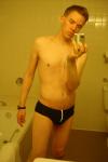 Black speedos, changing in a bathroom