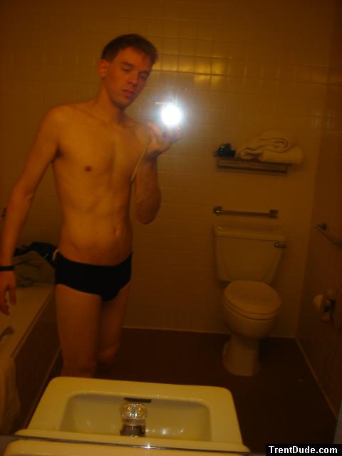 Black speedos, changing in a bathroom