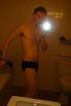 Black speedos, changing in a bathroom