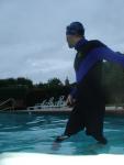 swimmer dude in wetsuit on cold day