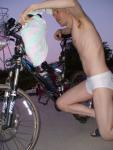 dude in speedo checks out his bike (best)