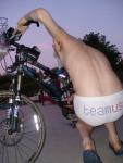 Dude in speedo checks out his bike (rear)