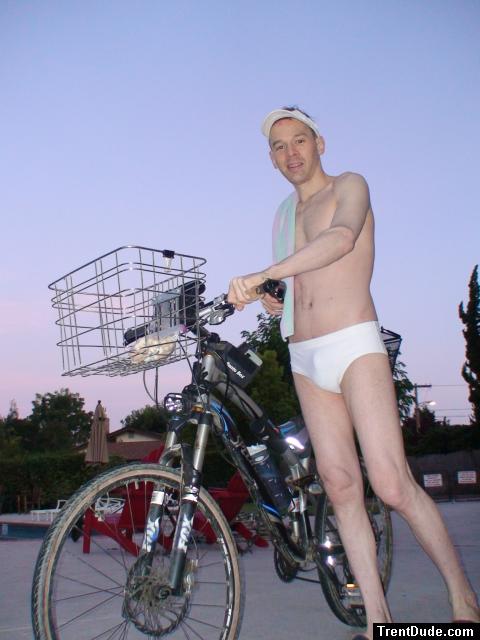 hoping no one notices his front basket with a bag of peanuts