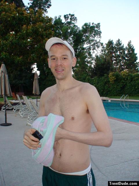 smiling with addidas shorts and white speedo underneath 