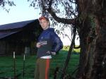 Standing by eucalyptus tree in Addidas sweat pants