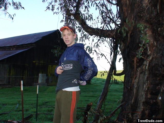 Standing by eucalyptus tree in Addidas sweat pants