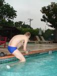 Stretching in a blue Nike speedo (butt!)