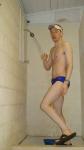 Showering after a swim in blue Nike swim brief (butt)