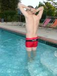 Swimmer flexing his back muscles (in a Red Speedo Curve Line Square Leg Trunk from InternationalJock.com)