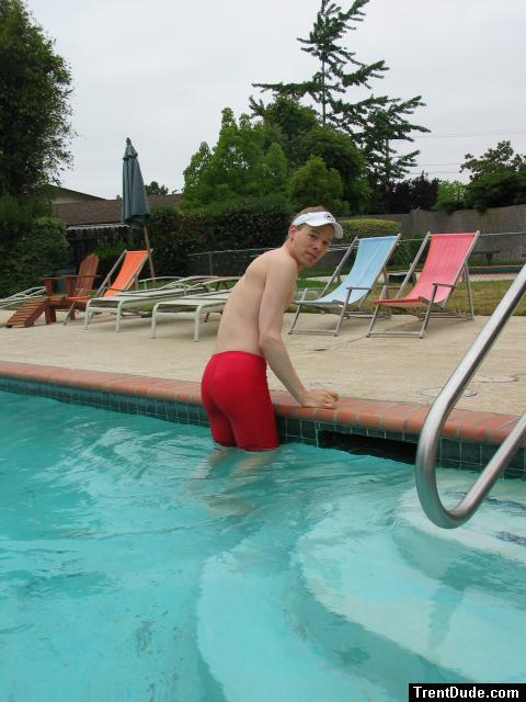 Climbing out of the pool in a red swim jammer