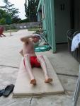 Swimmer doing stretches in a red jammer