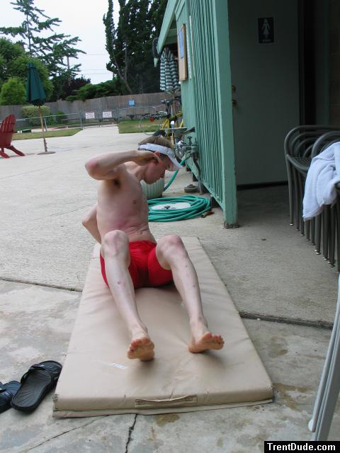 Swimmer doing stretches in a red jammer