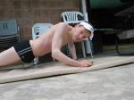 Doing pushups in a Speedo drag suit (toned)