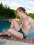poolside in Nike green speedo