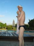 Drying off after a swim  in a blue speedo brief