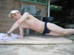 doing a pushup wearing a navy blue Speedo Solar 1" Swim Brief from Macys.com