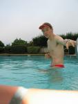 In the water wearing a Red Speedo