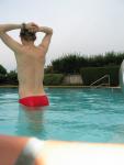 Swimmer stretching in a Red speedo