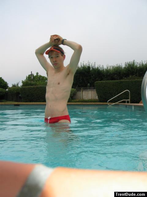 Showing his armpit in a red Speedo