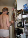 Checking out the refigerator in stained underwear