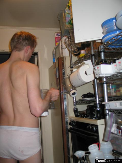 Checking out the refigerator in stained underwear