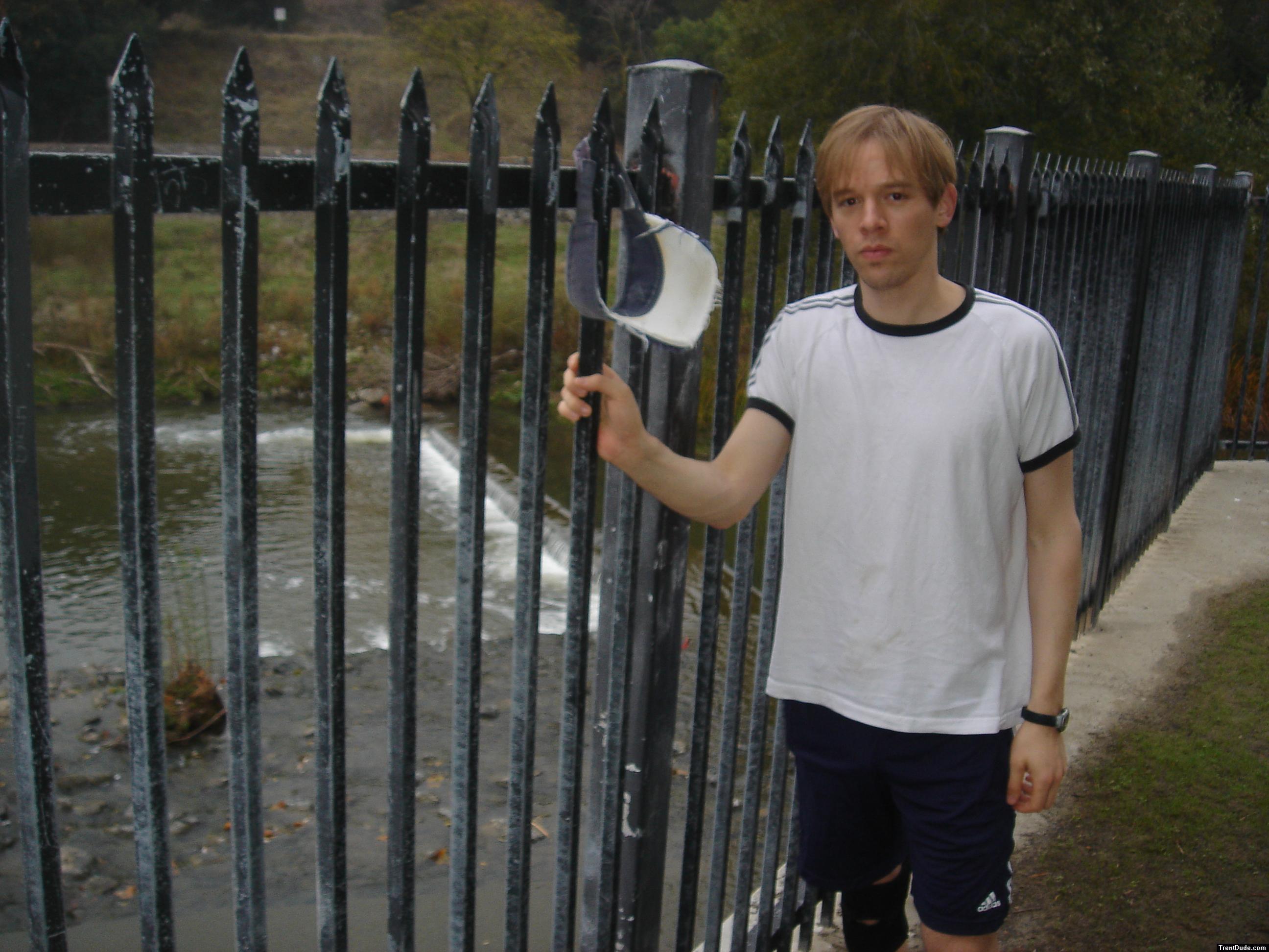 Dude wearing a t-shirt outside by a creek