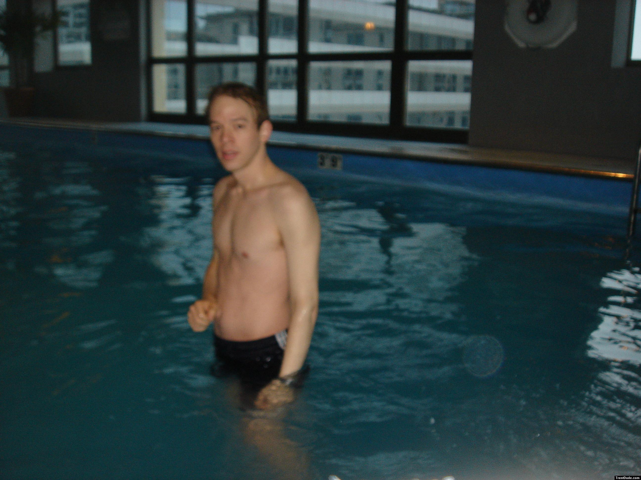 Trent in a pool with building in the background
