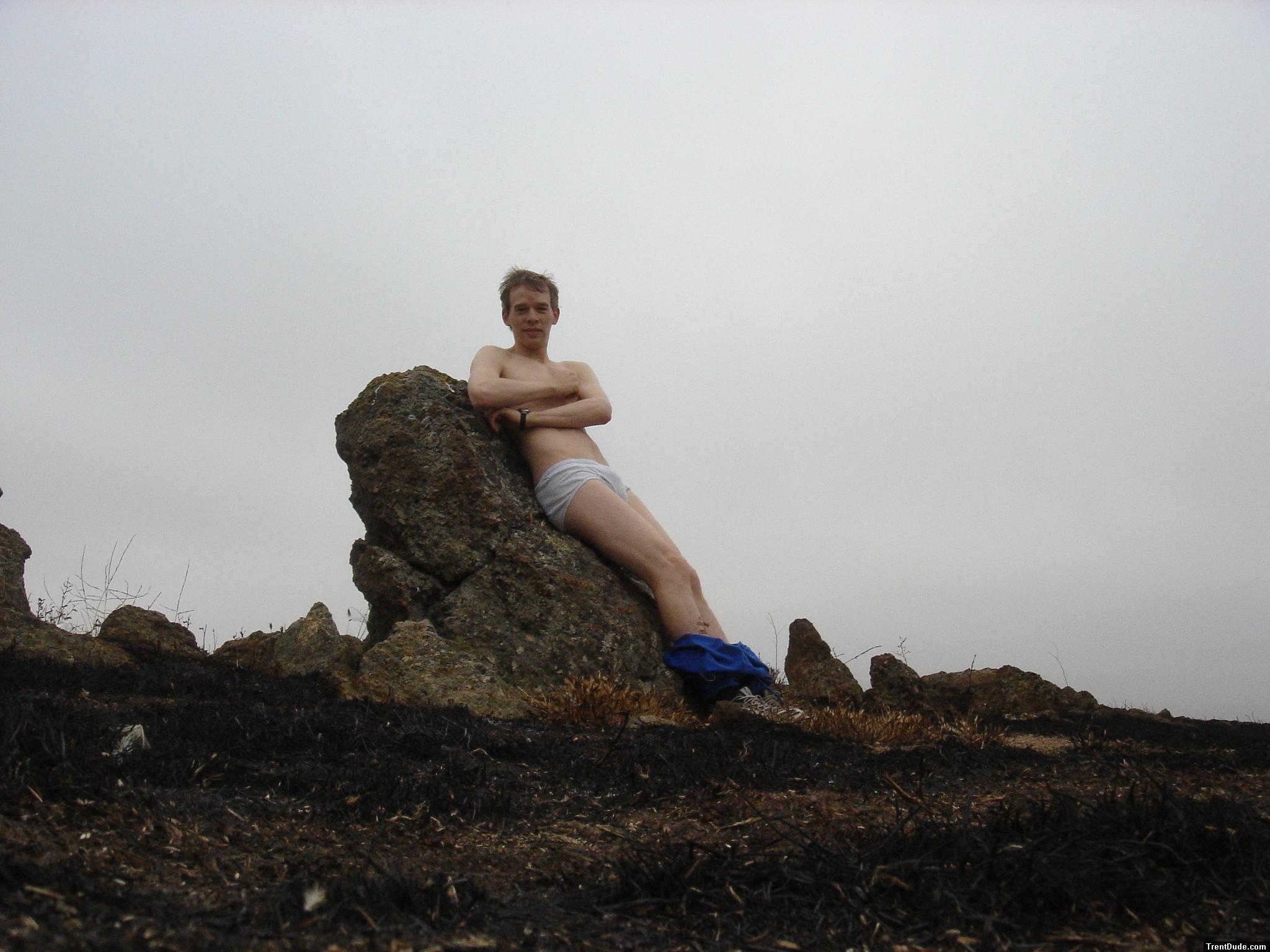Hiker sitting on rock in white hanes underwear