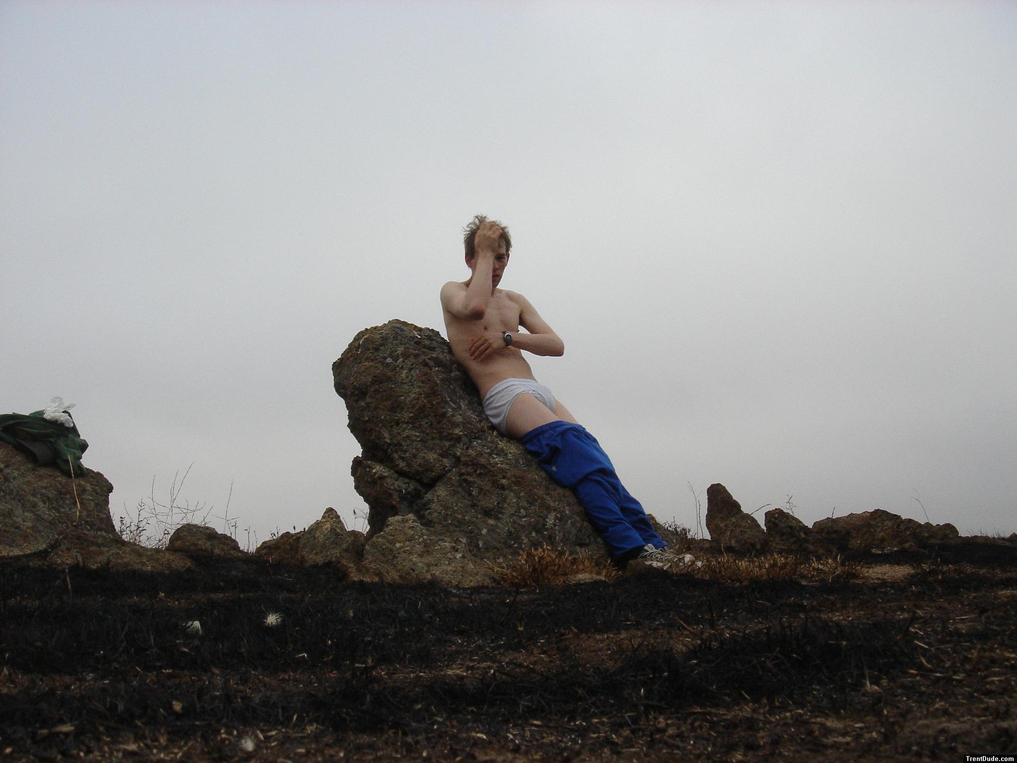 Hiker sitting on rock in white hanes underwear