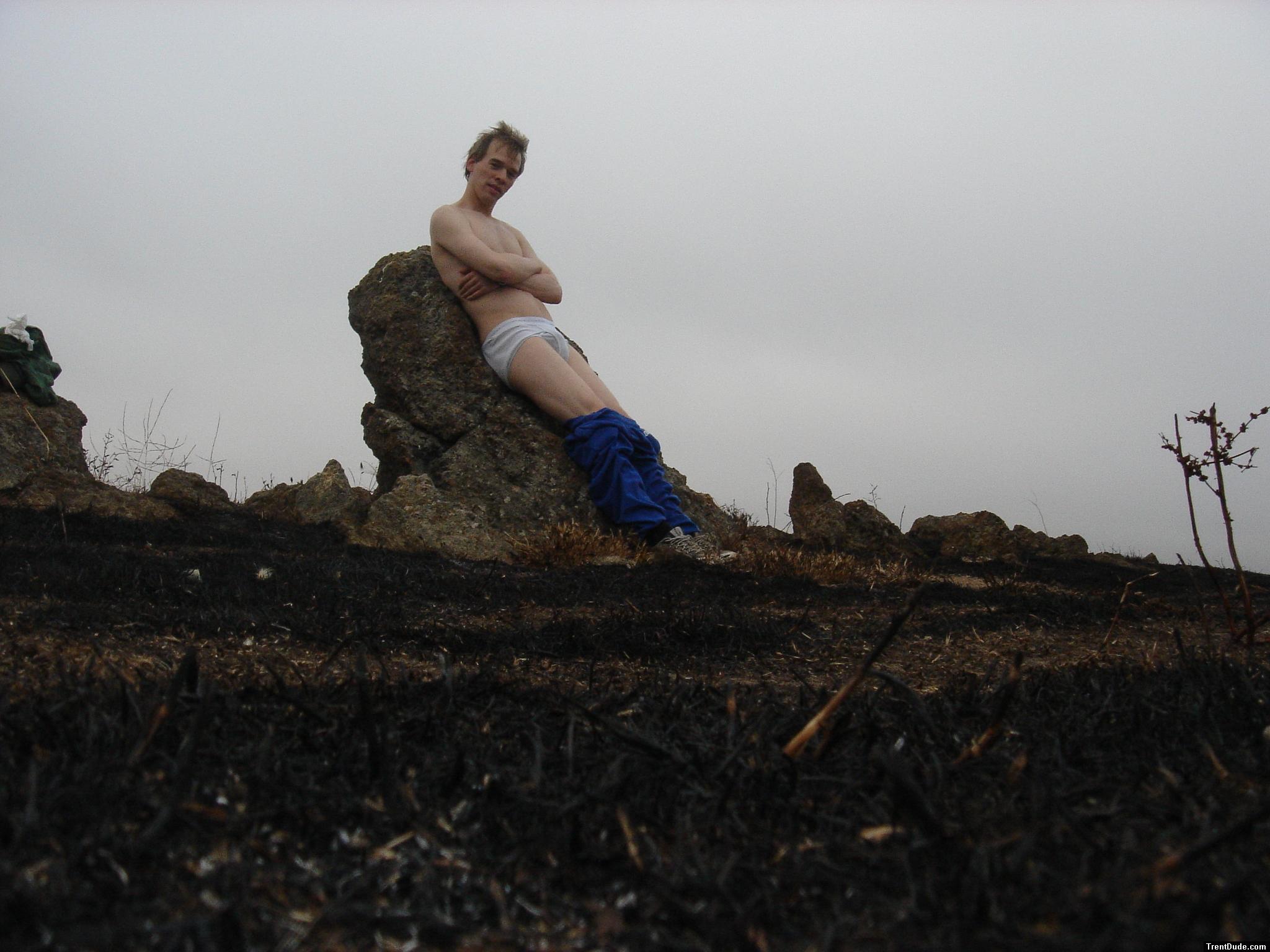 Hiker sitting on rock in white hanes underwear