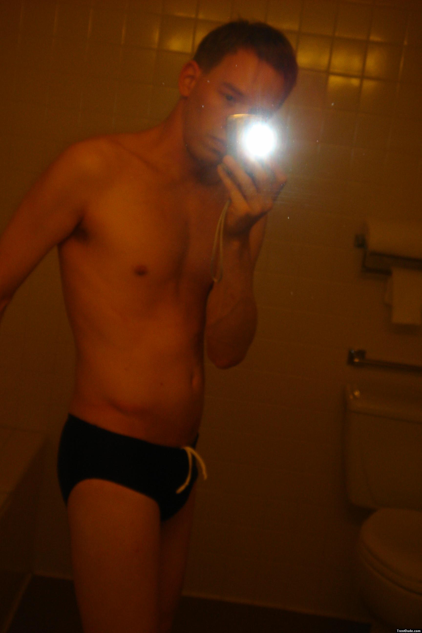 Black speedos, changing in a bathroom
