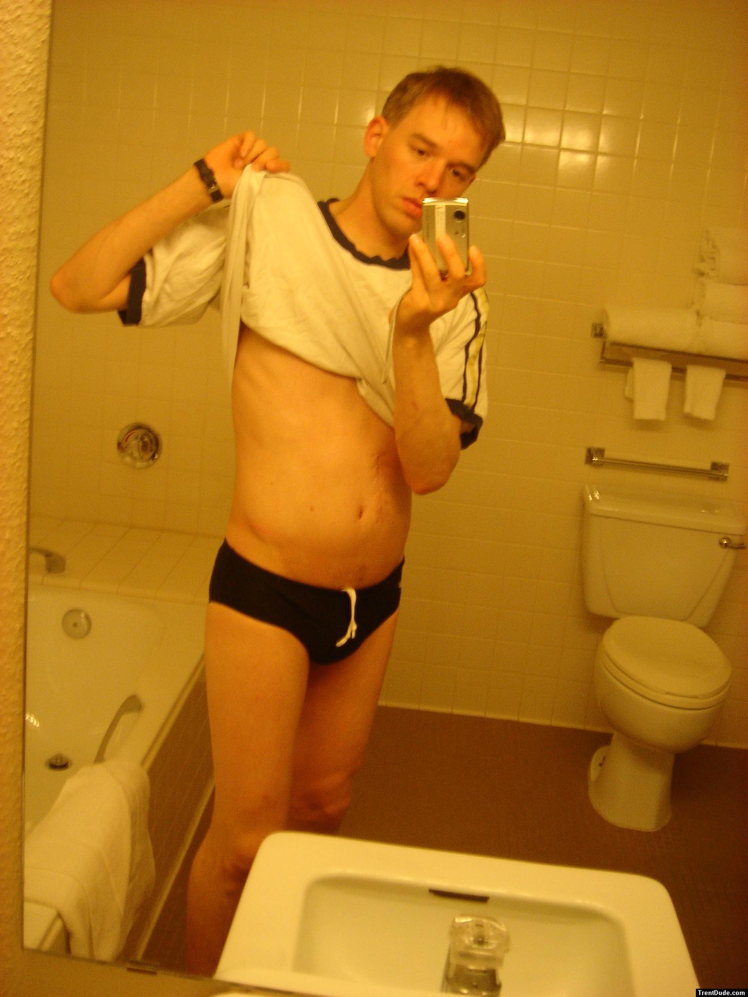 Black speedos, changing in a bathroom