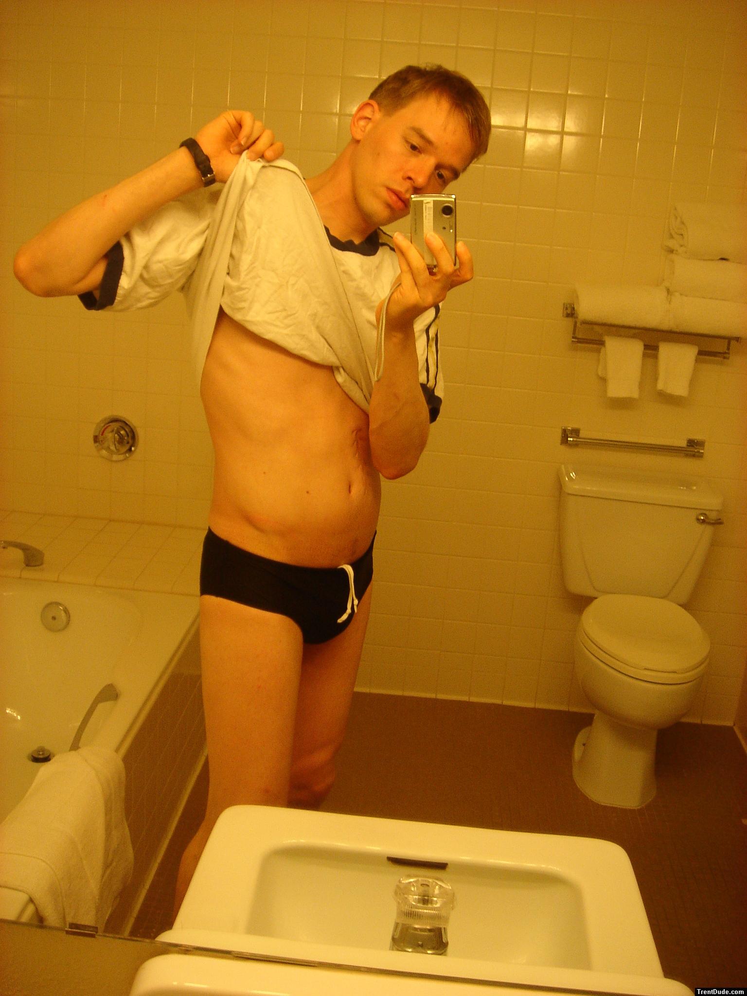 Black speedos, changing in a bathroom