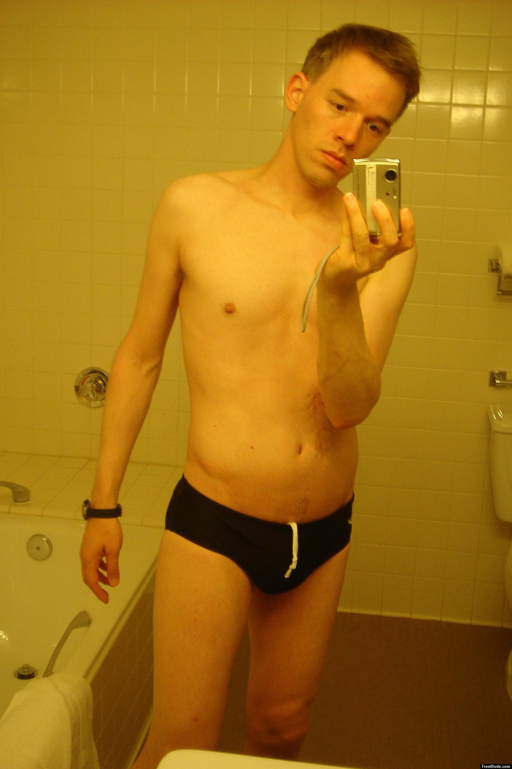 Black speedos, changing in a bathroom