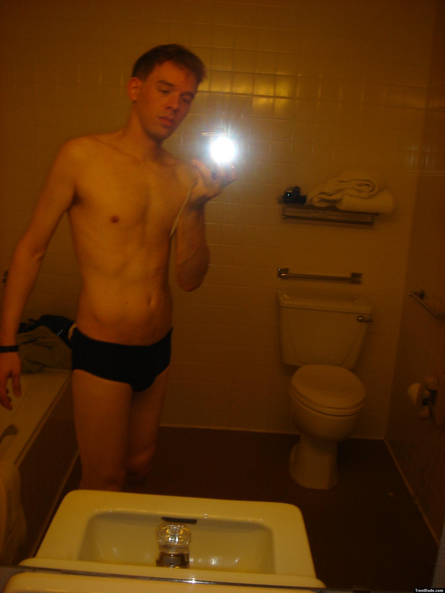 Black speedos, changing in a bathroom