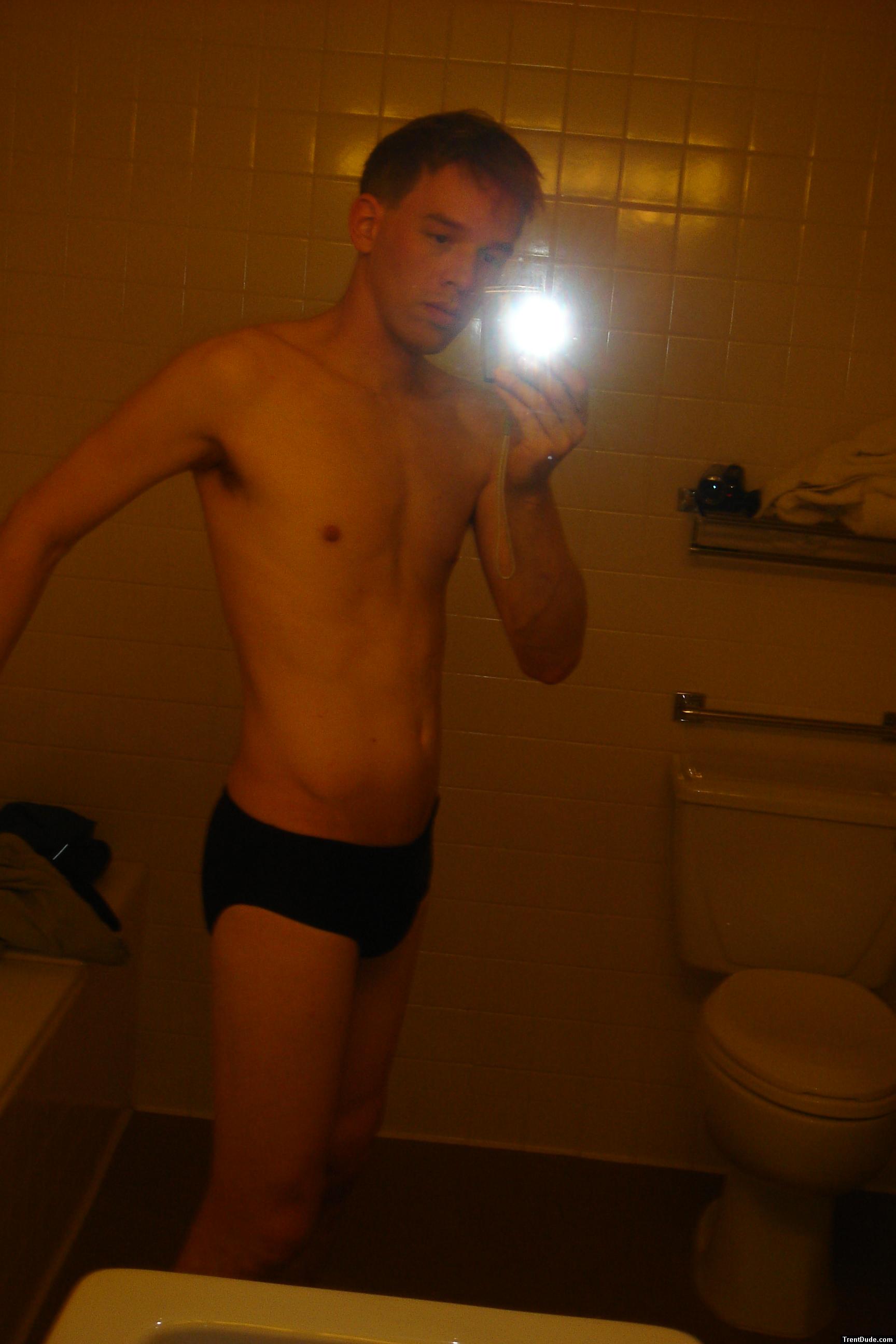 Black speedos, changing in a bathroom