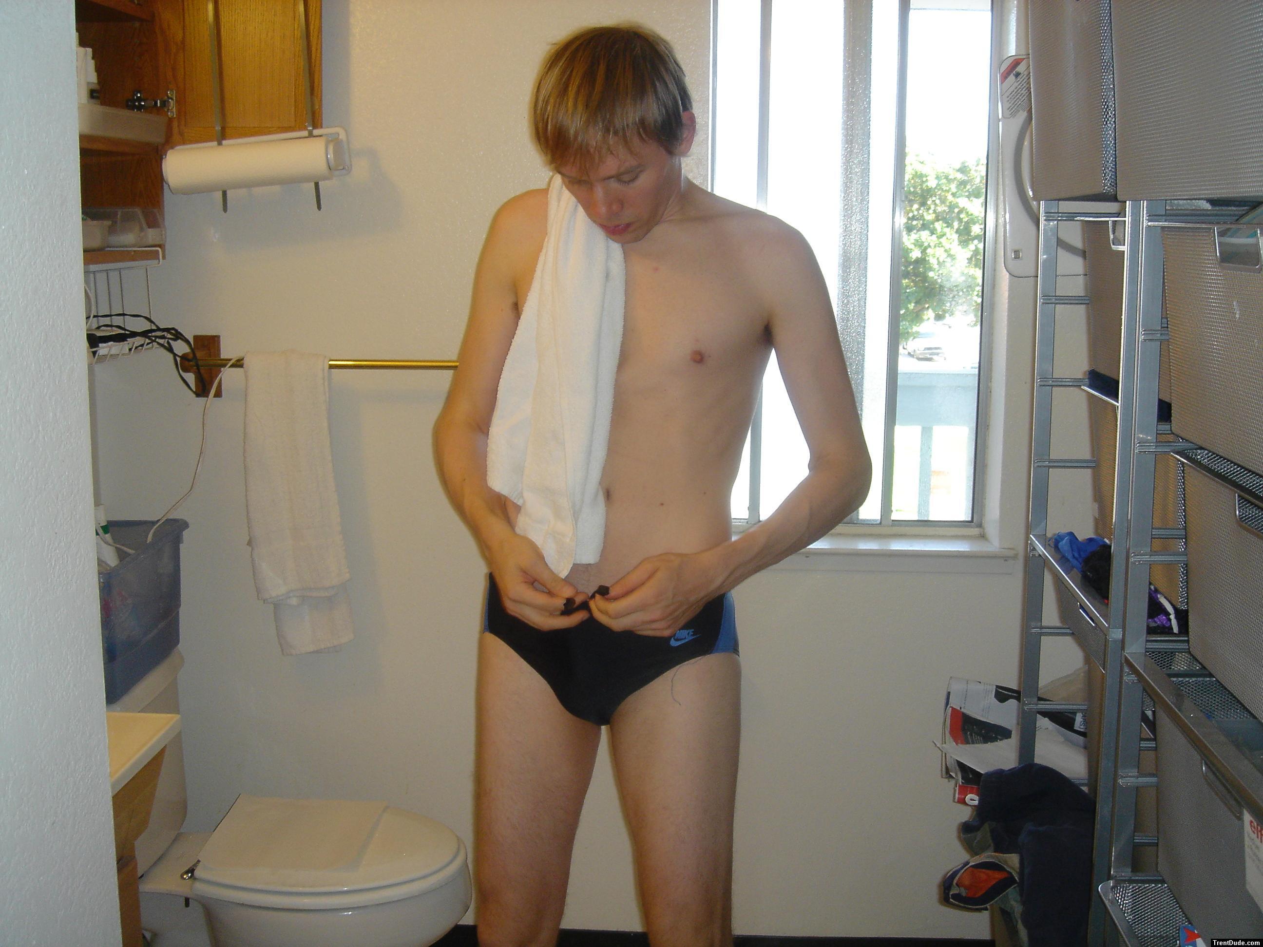 Golden hair swimmer trying to tie the Nike swim suit