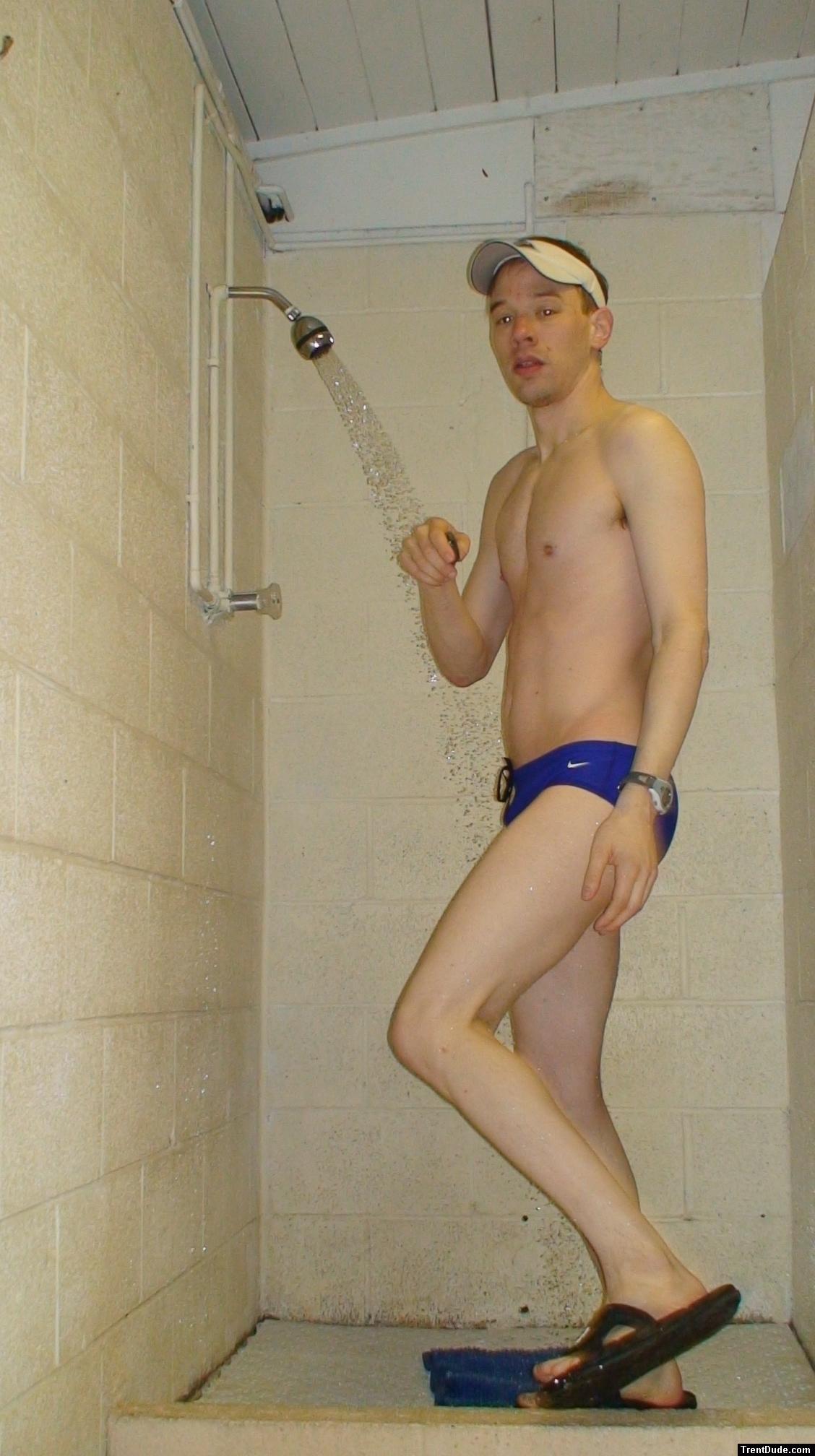 Showering after a swim in blue Nike swim brief (butt)