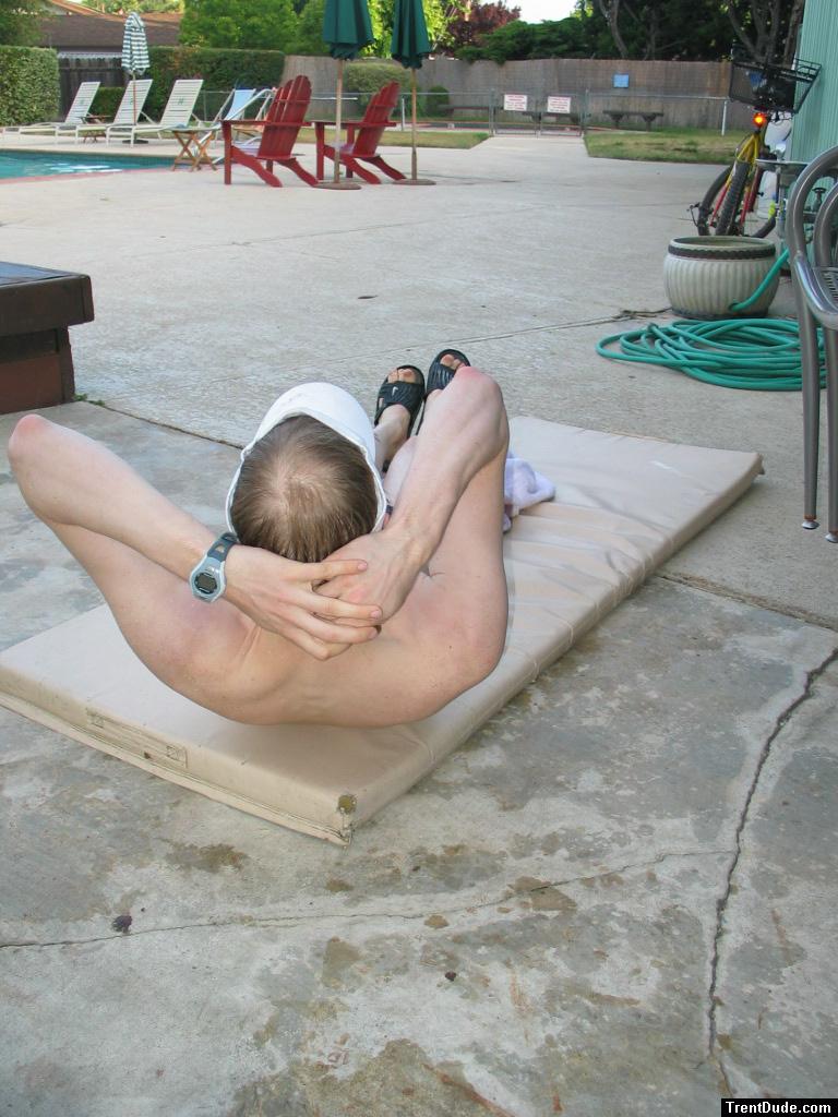 In the middle of a sit-up (bald)