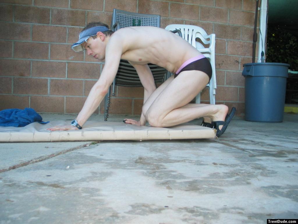 Swimmer in speedo getting ready to do push-ups