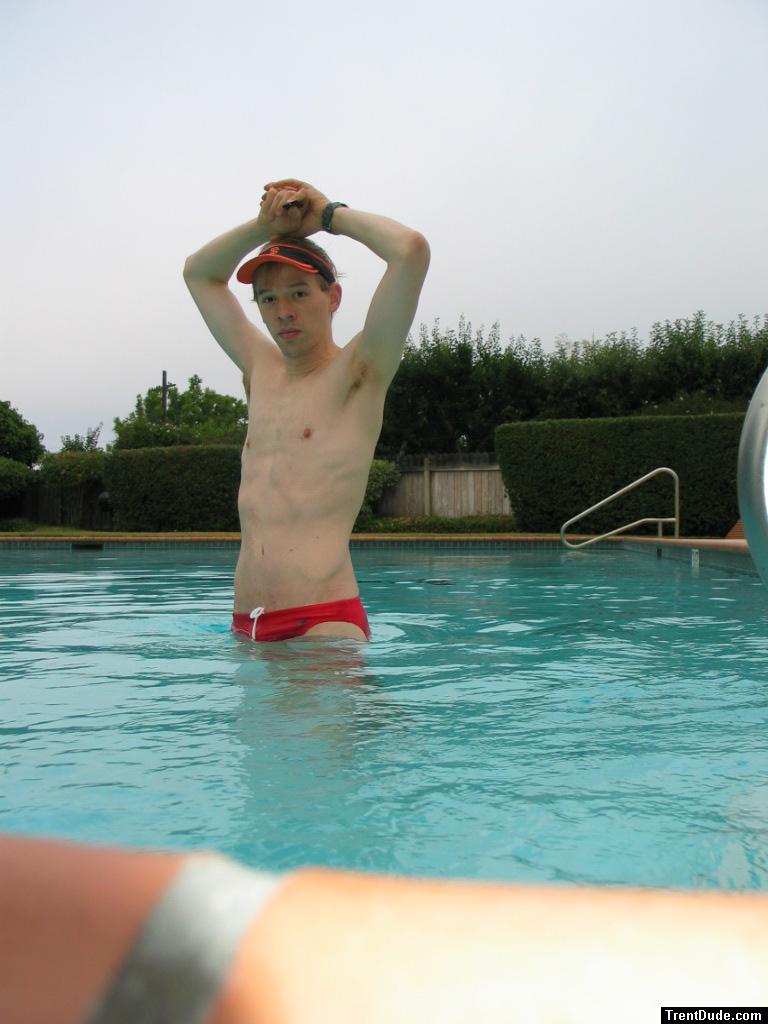Showing his armpit in a red Speedo
