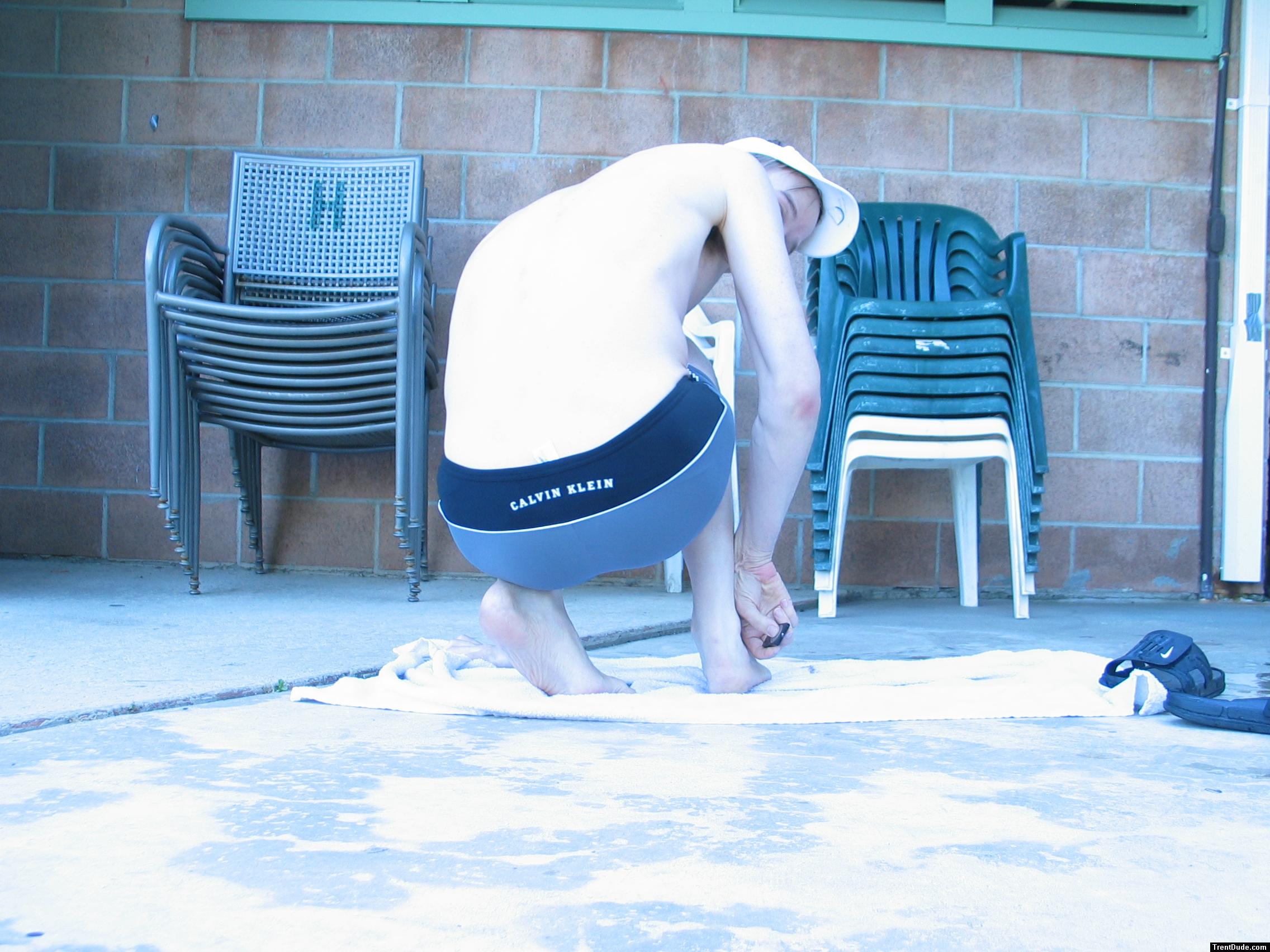 Showing his feet in a Calvin Kelin swim boxer (black/dolphin) from Macys.com