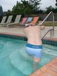 Stretching in a Calvin Klein swim boxer (rear)
