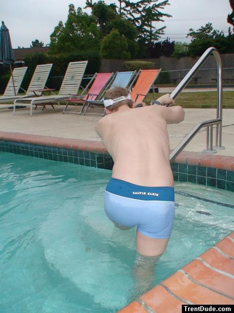 Stretching in a Calvin Klein swim boxer (rear)