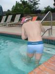 Stretching in a Calvin Klein swim boxer (rear)