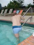 Stretching in a Calvin Klein swim boxer (rear)