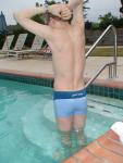 flexing his back muscles - Calvin Klein swim boxer (rear)