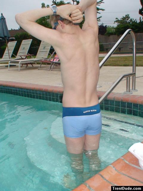 flexing his back muscles - Calvin Klein swim boxer (rear)